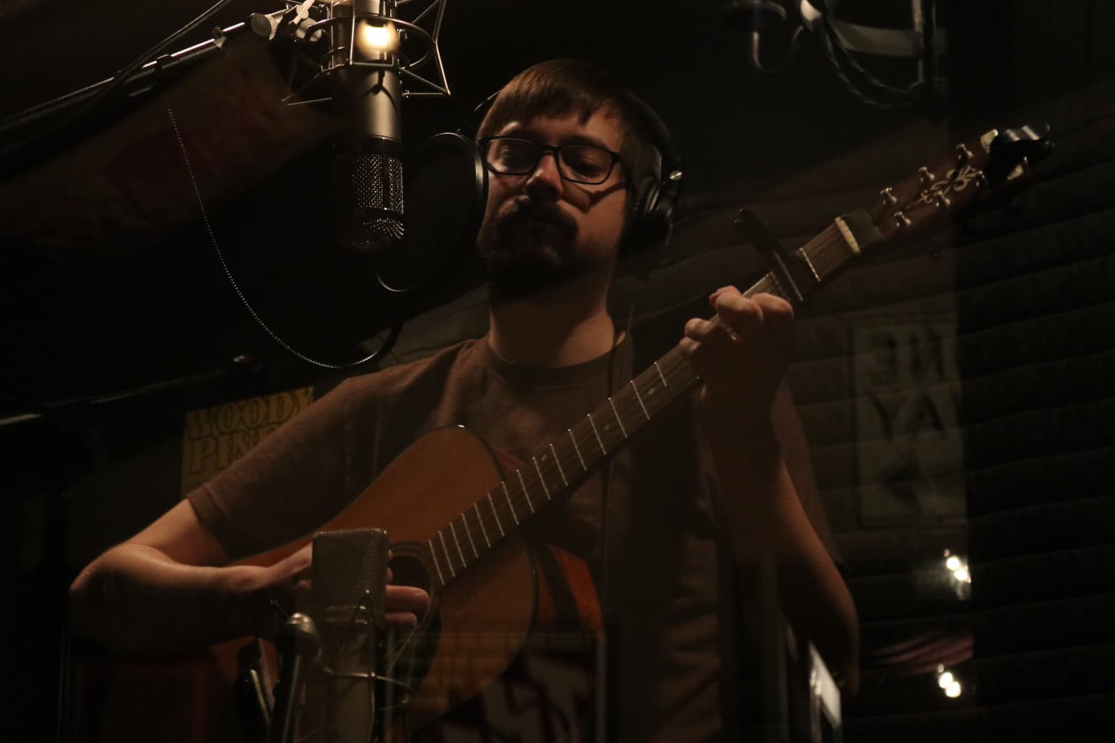 Cody Clark, seen performing guitar during the recording of Tall Tales & Fables